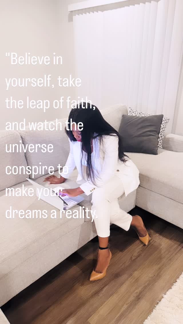 Malorfa in a white suit working on a laptop