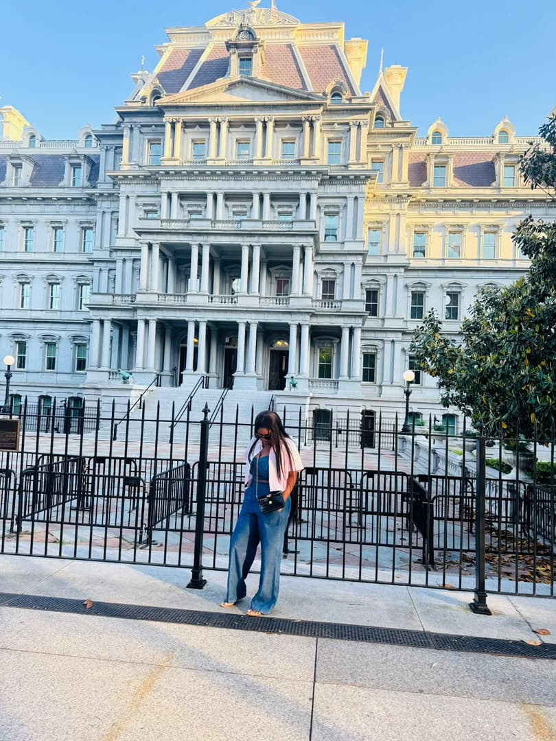 Malorfa outside a grand historic building on a sunny day